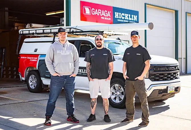 Employees of Hicklin Garage Door Services Lincoln standing in front of their service truck.
