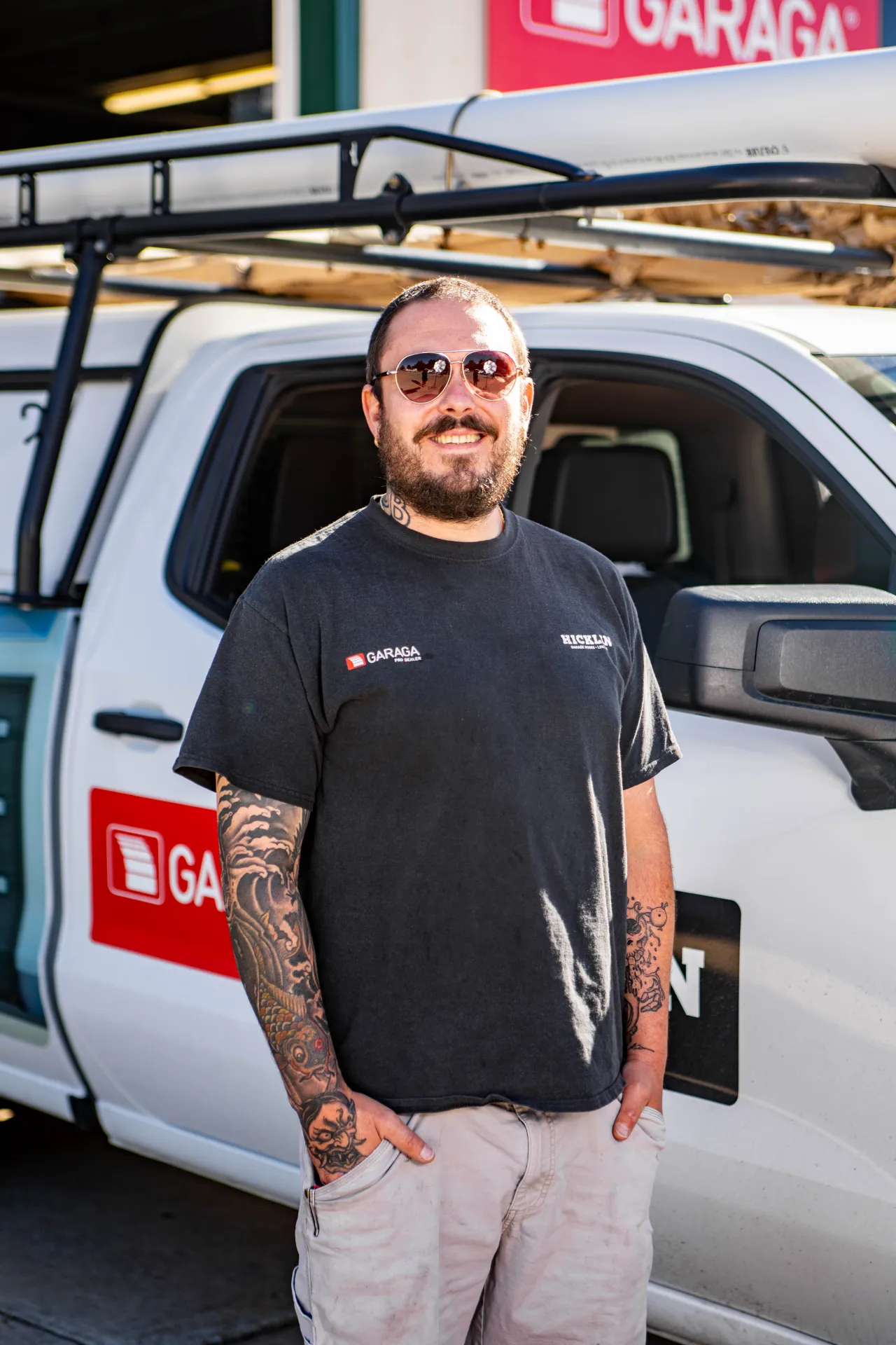 Hicklin Lincoln Garage Doors installer smilling in front of service truck